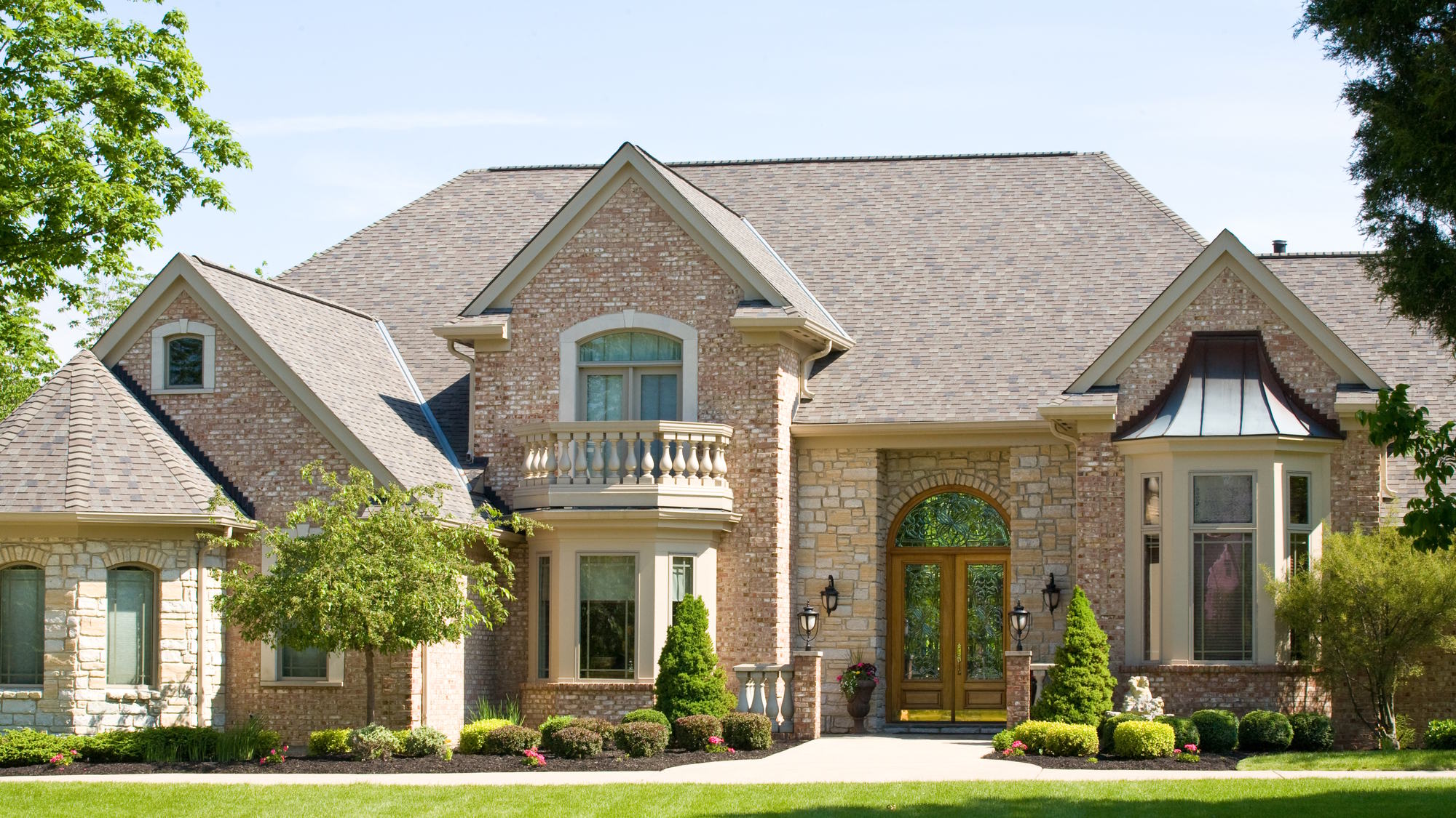 Couple sitting together on couch looking at laptop